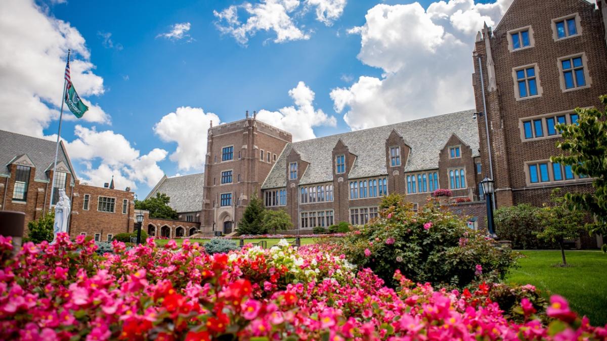 Old Main with flowers in the foreground