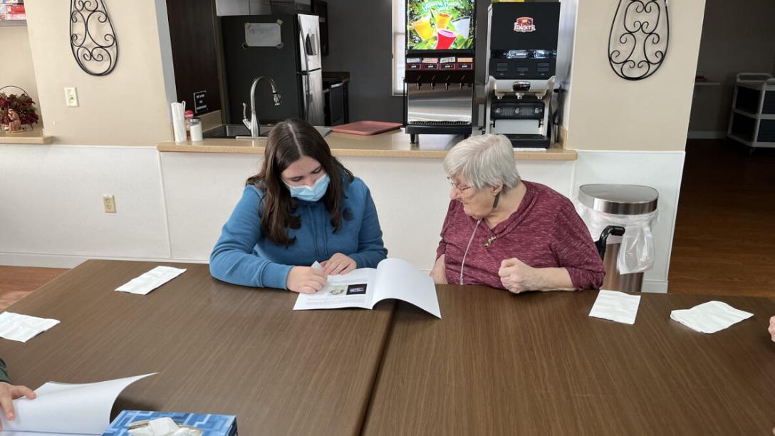 Student Connecting with Elmwood Garden Resident